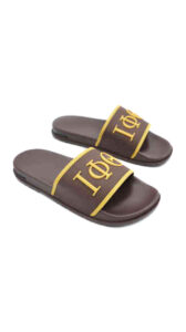 A pair of brown sandals with yellow and white lettering.