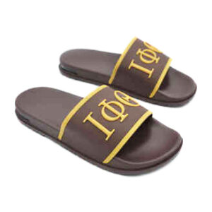 A pair of brown sandals with yellow and white lettering.